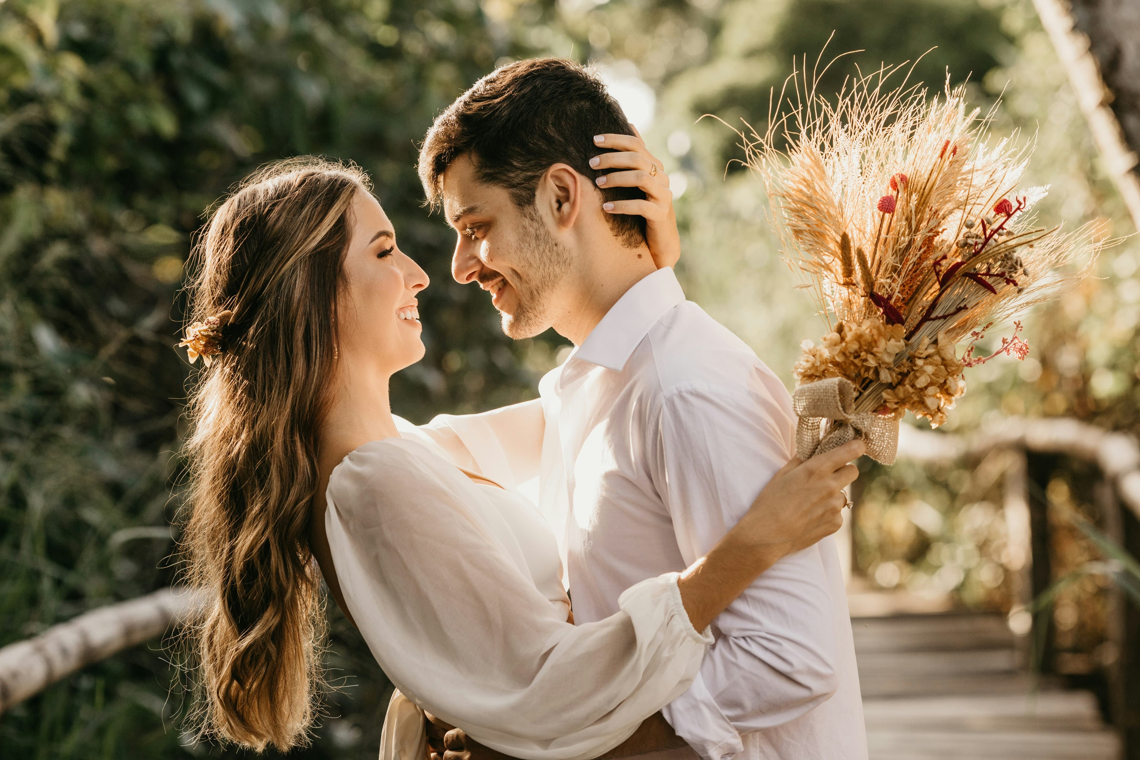 A couple holding each other close in warm evening light