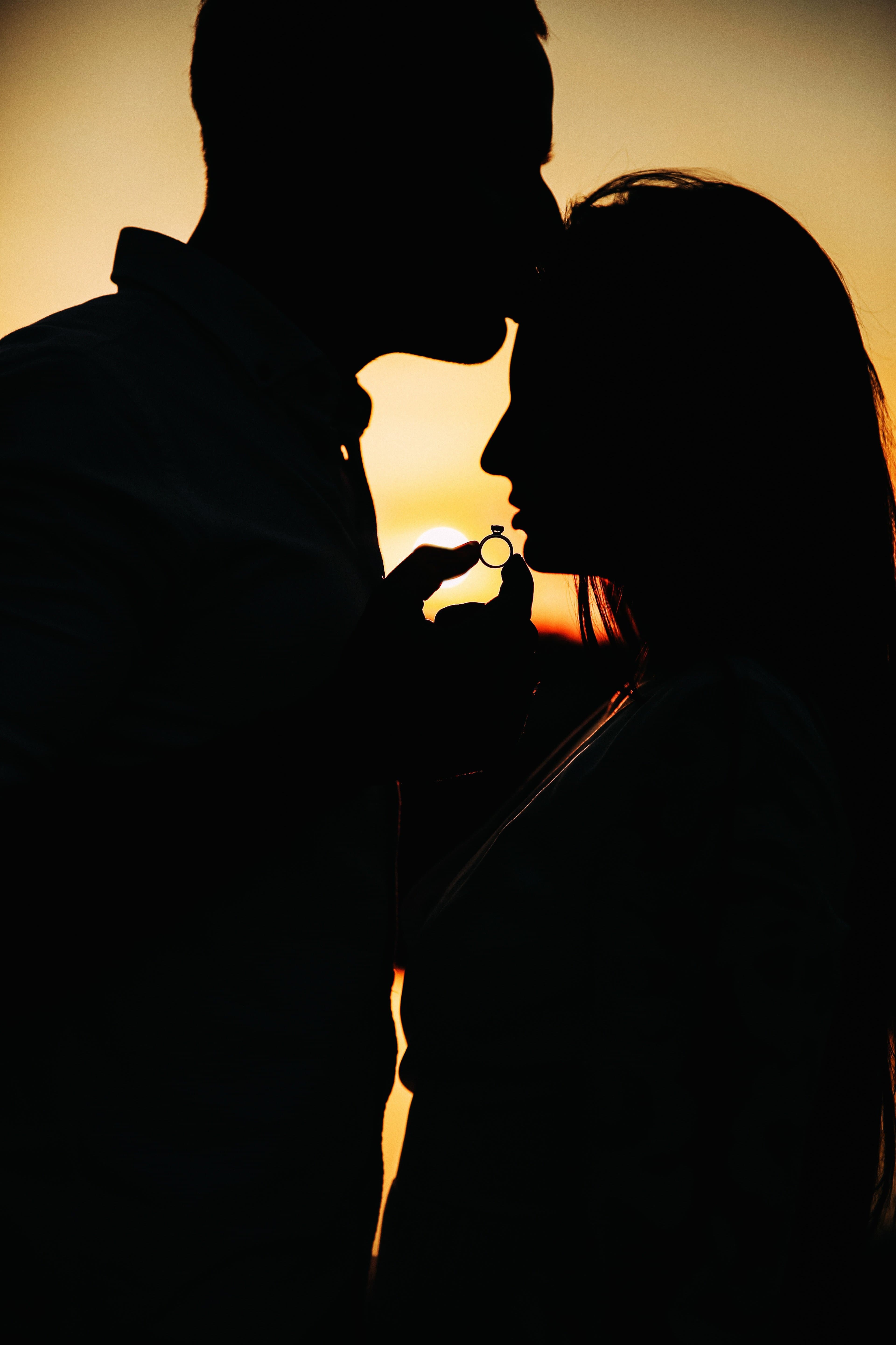 A couple silhouetted against the sunset on their wedding day